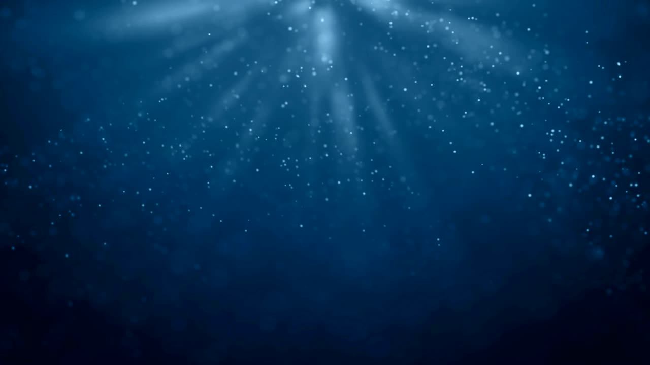 seamless loop of deep blue ocean waves from underwater background with particles flowing movement, light rays shining