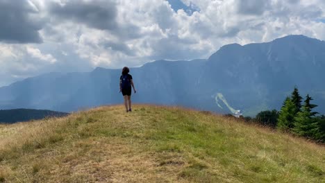 a girl hiking in the carpathian mountains of romania near busteni city