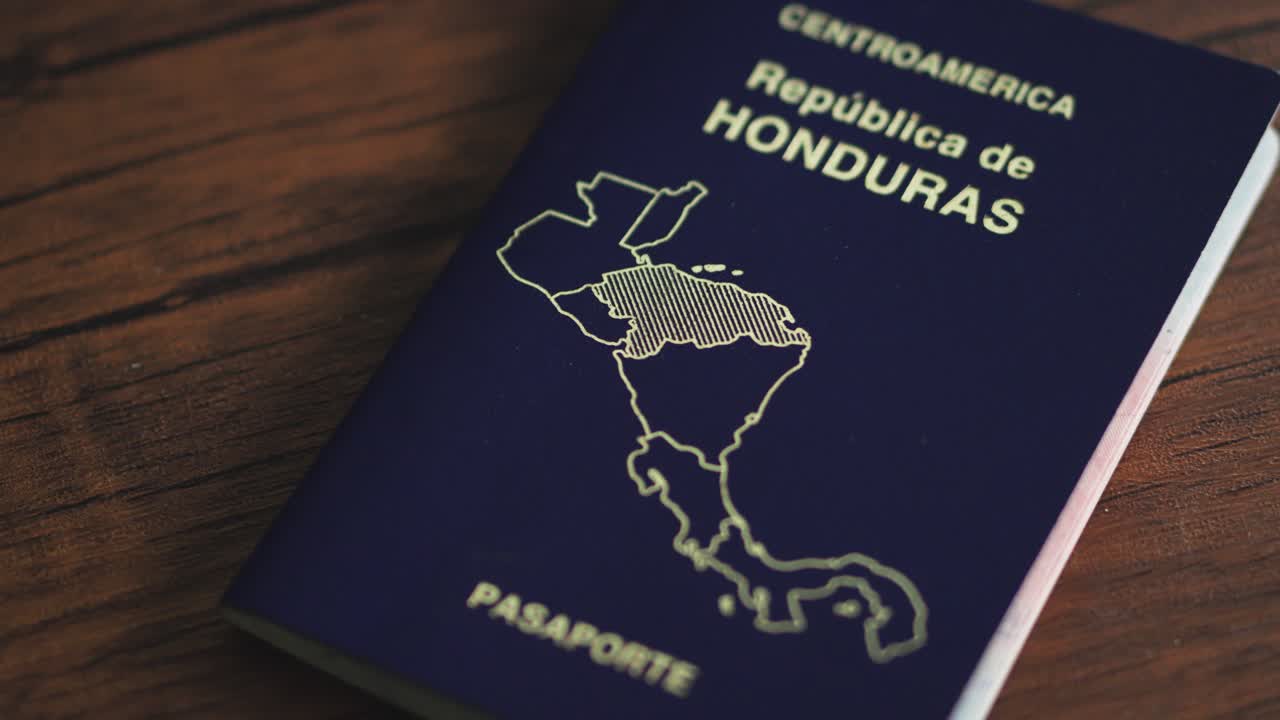 Close-up of official Honduran passport document on a wooden surface