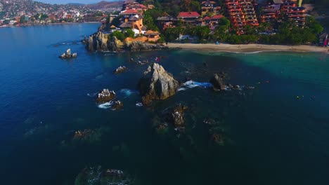 pushing out and tilting up to reveal a gorgeous development on the peninsula of a beautiful city on the pacific ocean in mexico