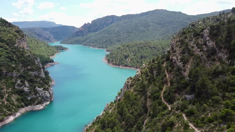 congost de mont rebei canyon at ager, catalonia and aragon, spain - aerial drone view of the blue noguera ribagorzana river, hiking trail and green mountains