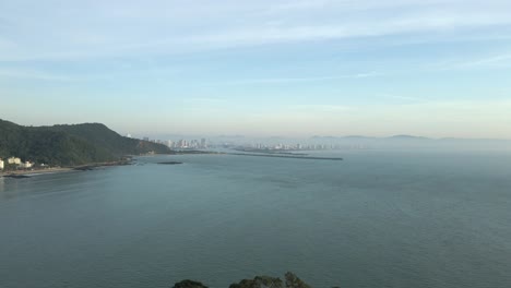 South-American-Coastline-with-Distant-Brazilian-City,-Aerial-Dolly-In