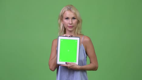 young happy beautiful businesswoman showing digital tablet
