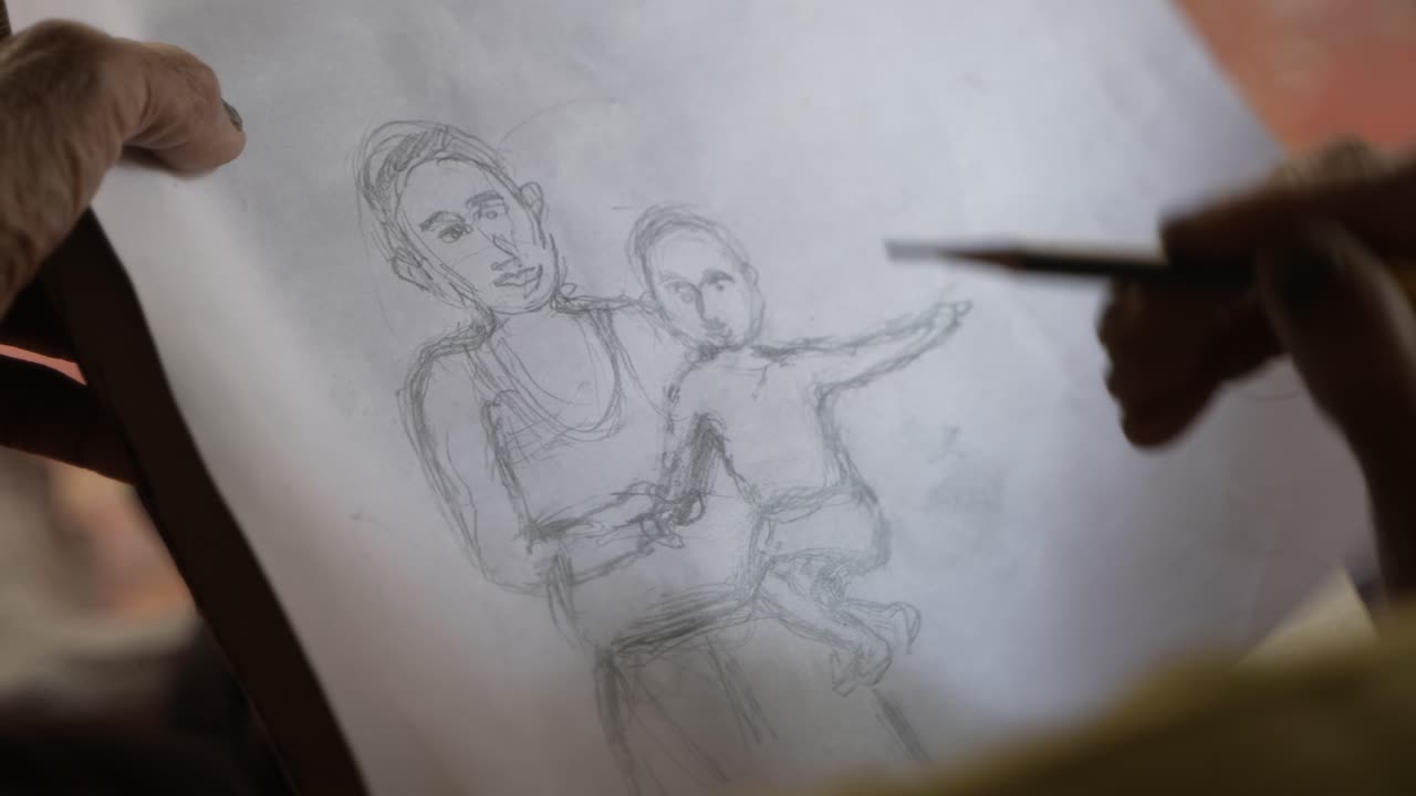 A person is drawing something with a pencil.