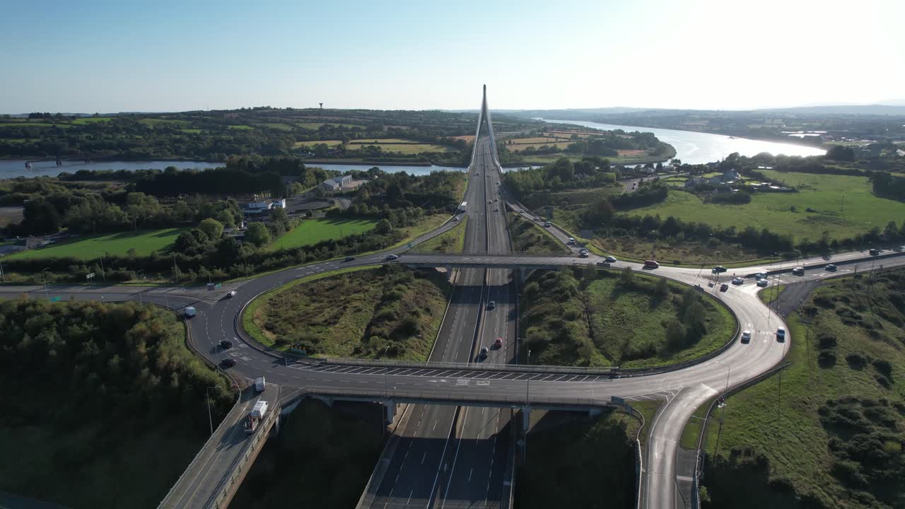 ireland Epic Locations drone flying over roundabout leading traffic to The Thomas Francis Meagher bridge over The River Suir Waterford Ireland at rush hour