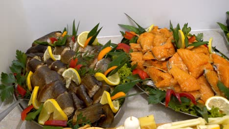 platters with smoked fish, adorned with slices of lemon and orange