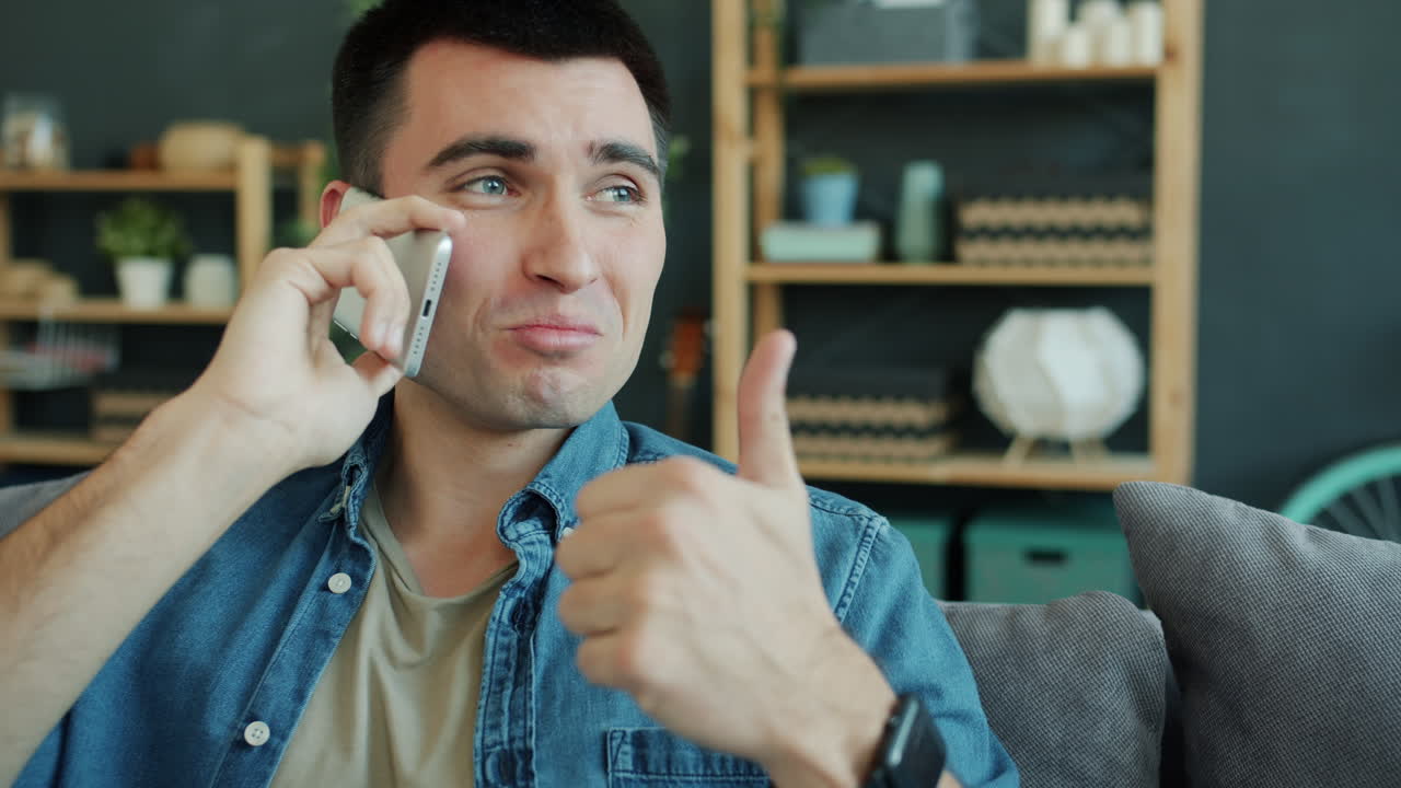 Man Talking on Phone and Giving Thumbs Up