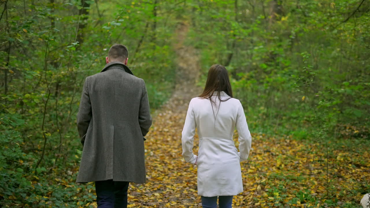 Couple walking in the forest during autumn