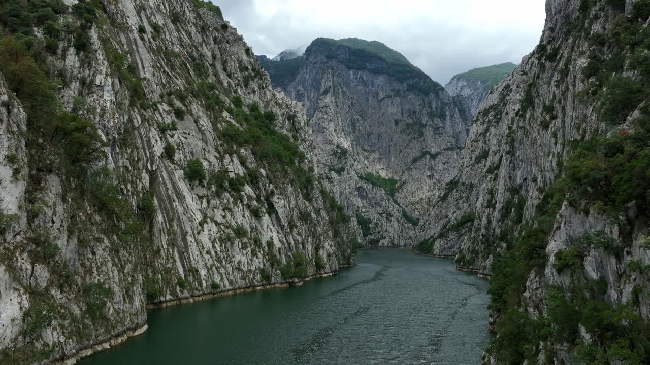 Komani Lake Surrounded By Towering Mountains Of The Albanian Alps In Kukes, Albania. drone pullback shot
