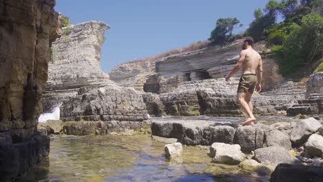 young man hiking on the cliffs.