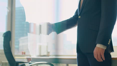 two businessmen shaking hands in office