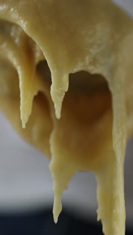 melted cheese/sauce dripping from a spoon