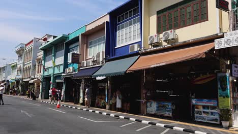 busy street with shops and pedestrians