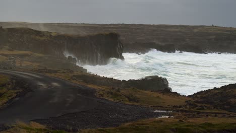 Ocean-Waves-Crashing-And-Splashing-Against-Rugged-Cliff