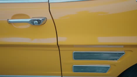 detail of vintage yellow car door and vent