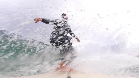 close up slow motion shot of handsome guy surfing a green wave in portugal