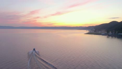sunset over a lake with boat