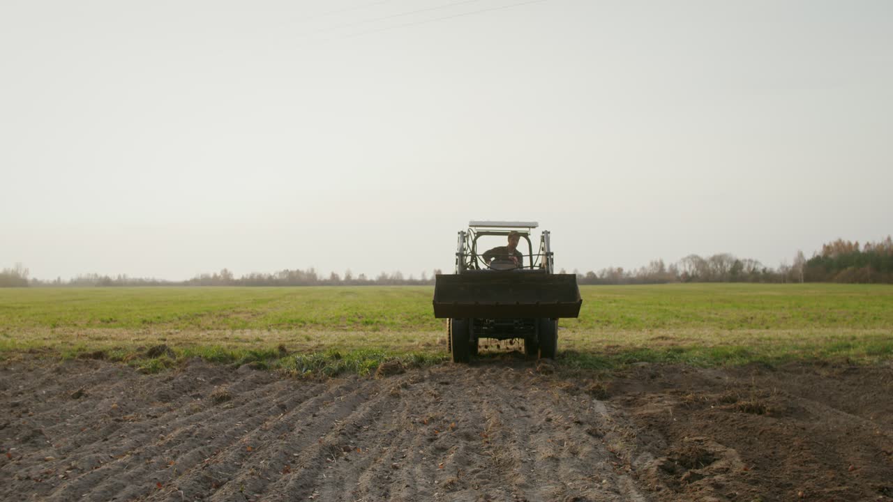 에서 트랙터를 운행하는 농부