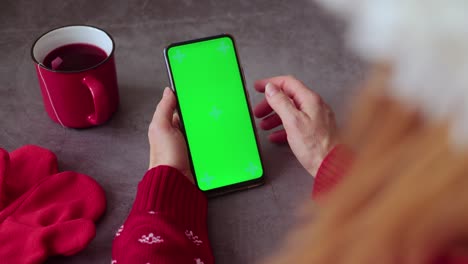 green screen pnone in hands. christmas time