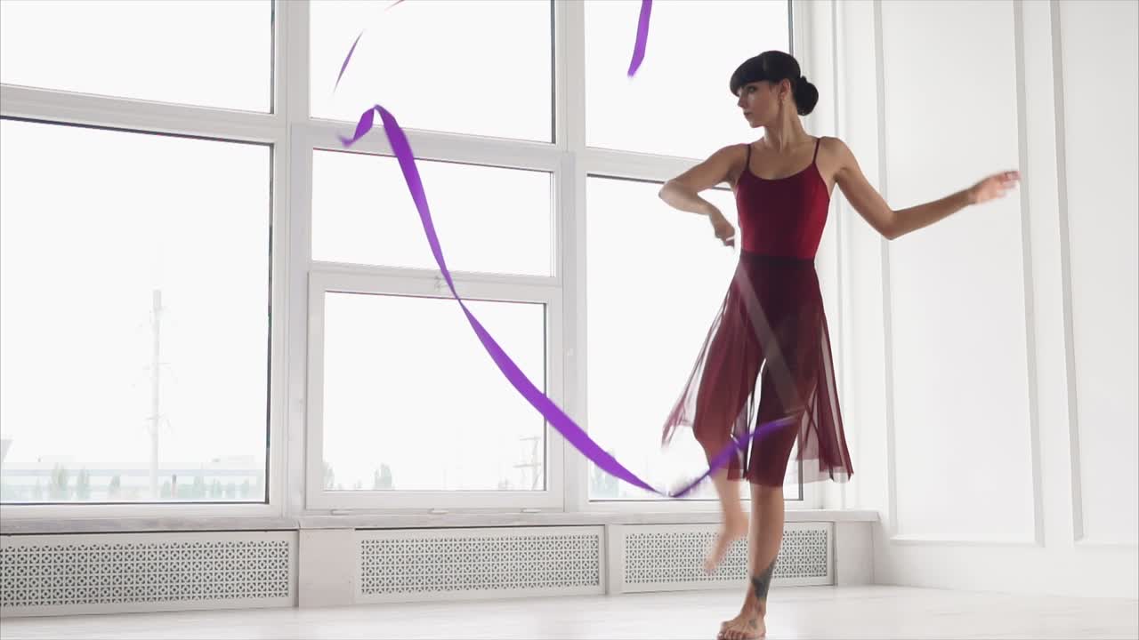 Woman performing ribbon dance in a studio