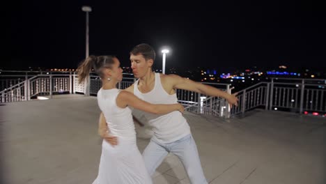 couple dancing on rooftop at night