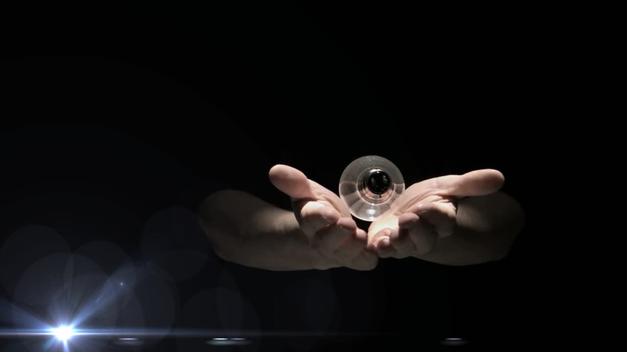 Point flare moving under bulb, hands guiding lifting rotating bulb then closing for lighting effect