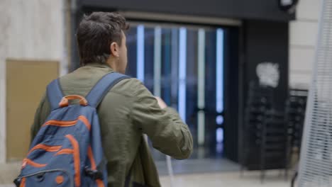 person walking outside a modern store