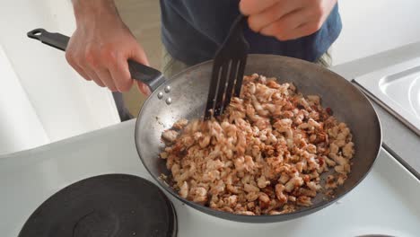 Pea-protein-strips-getting-mixed-with-various-spices-in-a-frying-pan