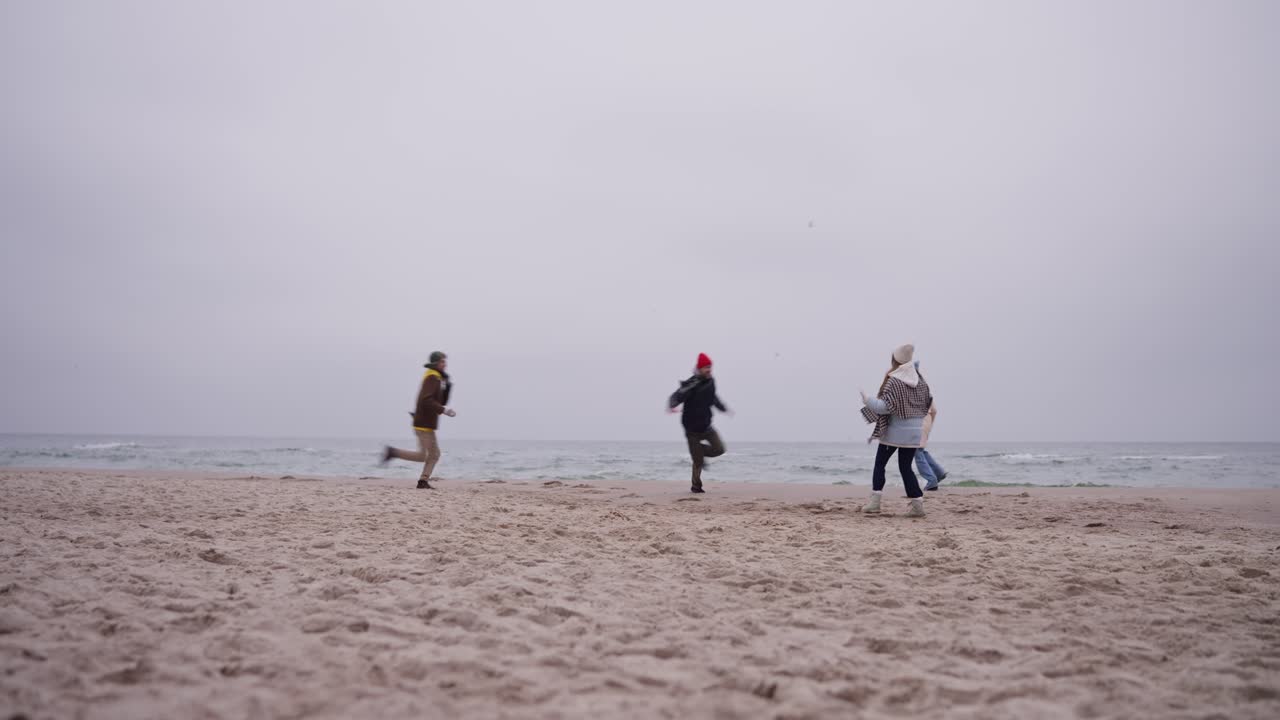 Friends having fun on a winter beach
