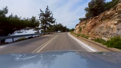 Driving-Through-The-Scenic-Thassos-Island,-Greece,-Driver-POV,-Grey-Car-Hood,-Mediterranean-Sea