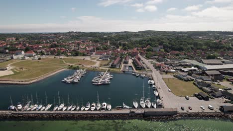 aerial view of coastal town marina with sail boats and vessels