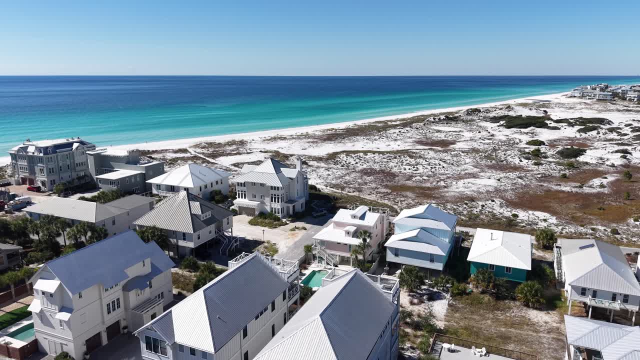 Upward drone fly over the coastal settlement to the beautiful turquoise Gulf of Mexico, 30A, Florida, USA