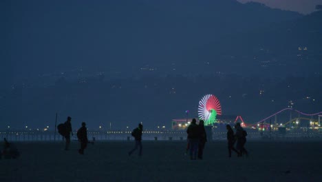 telephoto shot of famous santa monica pier from venice beach, california.