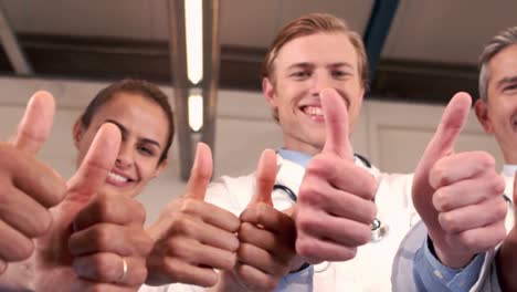 smiling medical team with thumbs up