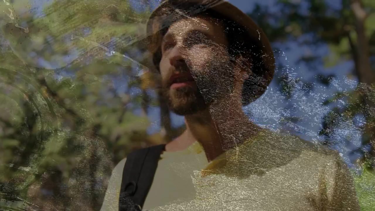Male hiker walking pines, after consulting compass scanning trees for outdoor nav, film scratches