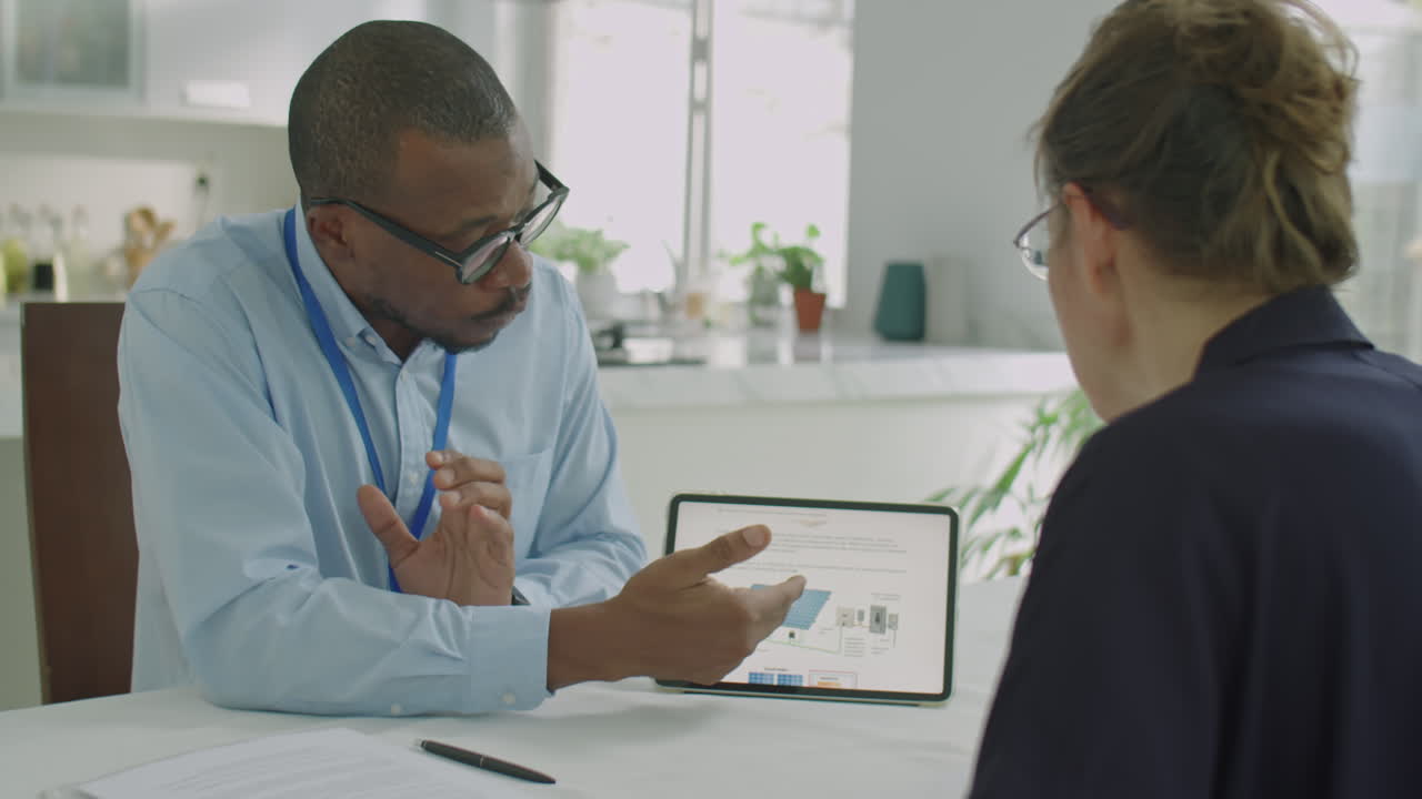 Engineer Explaining Solar Power Project on Tablet to Colleague