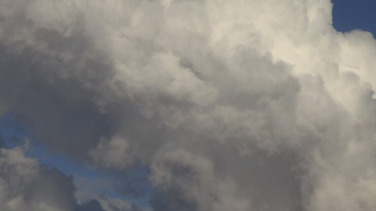 Gray clouds moving over the blue sky