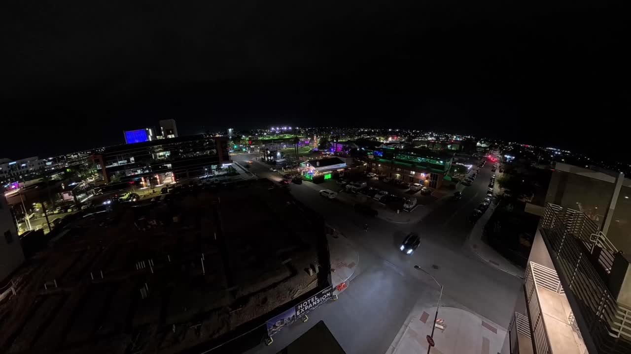Observer watching from a wall in a Panning Chandler Arizona Night Time Lapse of downtown city streets.