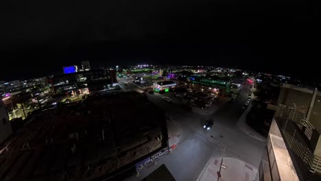 observer watching from a wall in a panning chandler arizona night time lapse of downtown city streets.