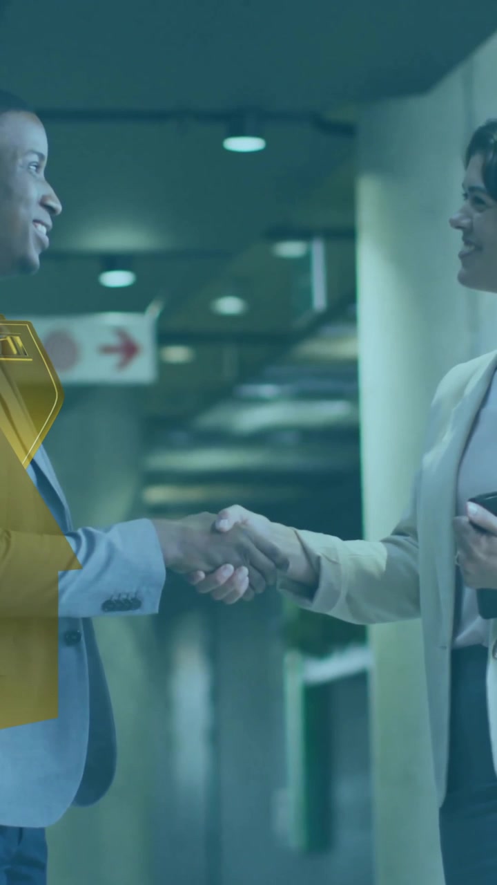 Animation of house and key over diverse colleagues shaking hands in office