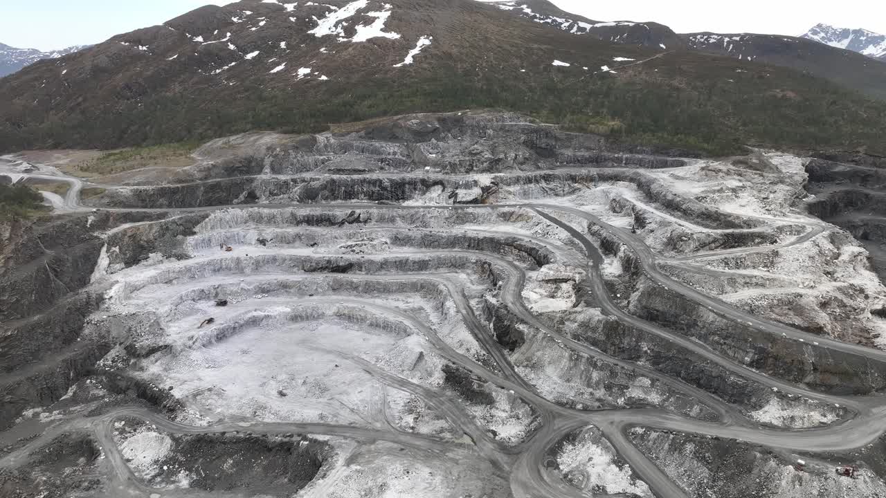 Mountainside totally damaged by mining activities at Visnes Kalk between Molde and Kristiansand in Norway - Roads and carved out patterns in destroyed mountain