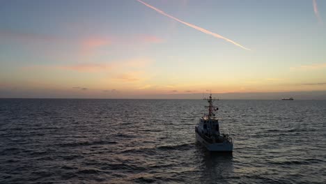 Küstenwachboot,-Das-In-Der-Abenddämmerung-Im-Ozean-Kreuzt