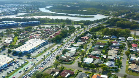 aerial drone overlooking busy coastal town road with traffic, 4k