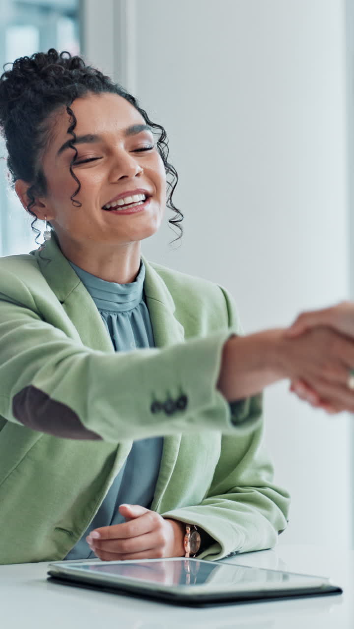 Business woman shaking hands after a successful meeting