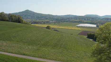 Drone---Aerial-panorama-shot-of-al-lonely-chapel-on-a-field-with-grass-and-a-road-with-panorama-of-the-seven-mountains---Siebengebirge-30p