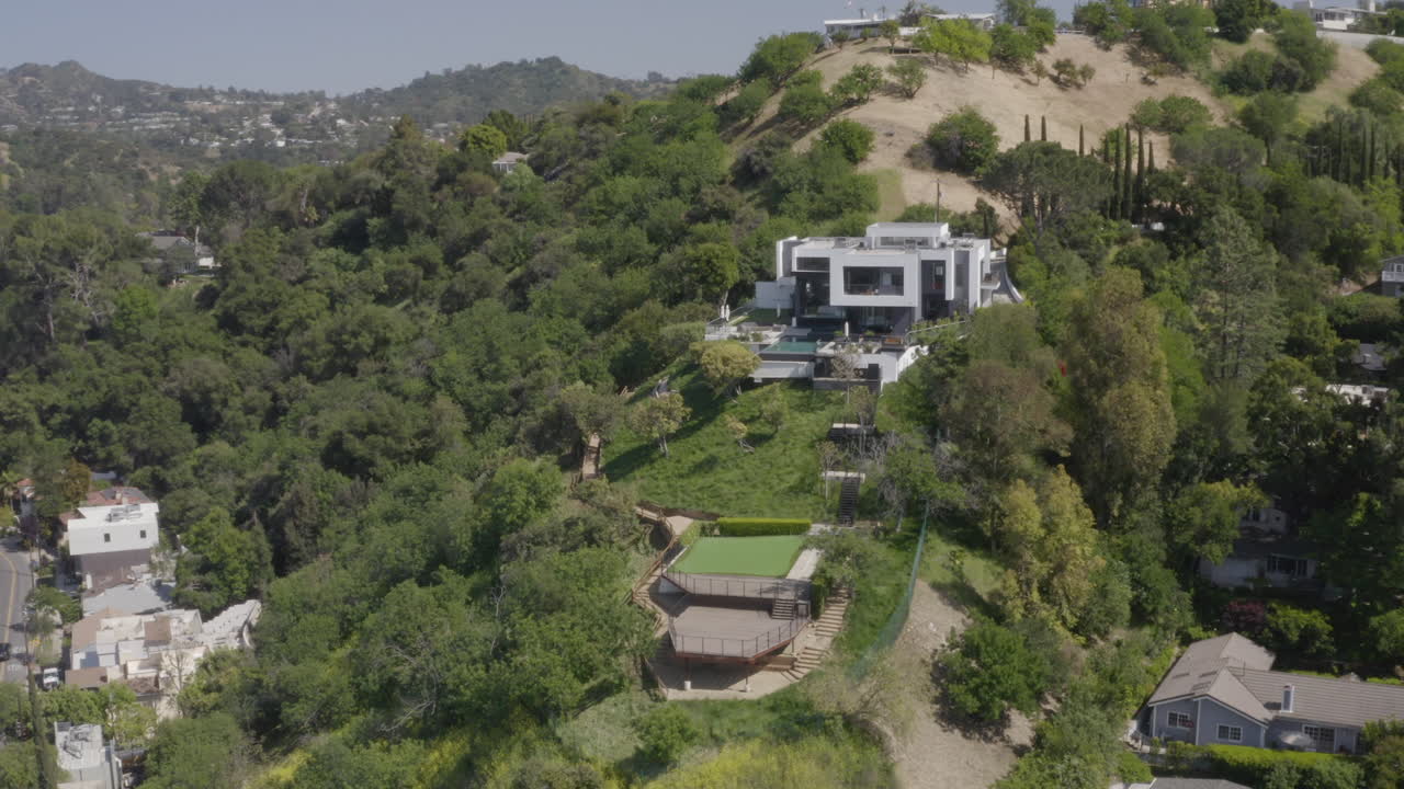 4K drone shot of modern hillside mansion is Studio City California.