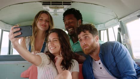 Friends-taking-selfie-in-camper-van-at-beach-4k