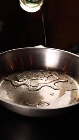 pouring oil into a pan