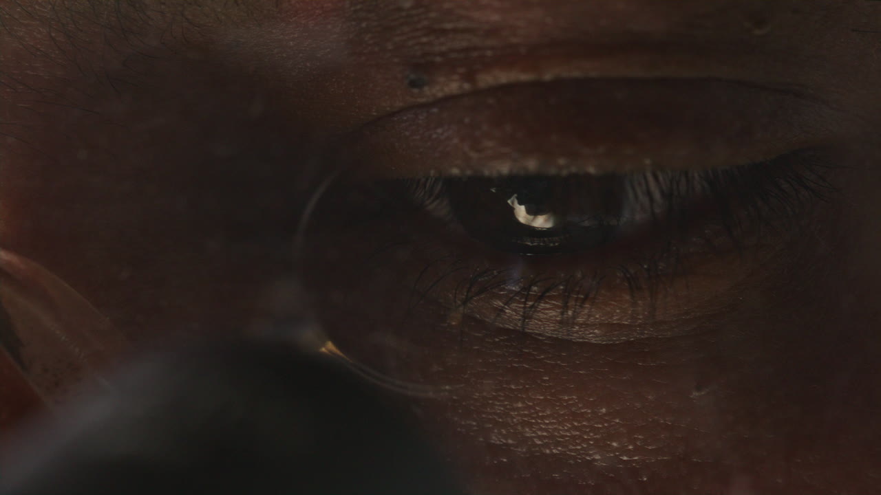 Eyes of Scientist in Glasses Analyzing Specimen through Microscope