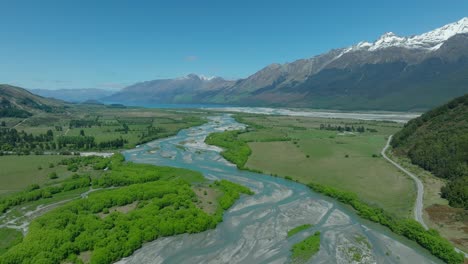 rees river meandering through bottomlands in mountain range, new zealand